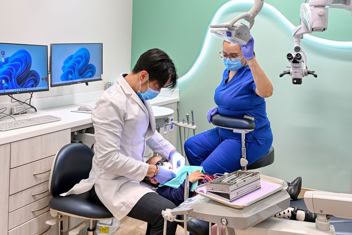Dentist and assistant working on patient at Le Pearl Dental in Alexandria, VA